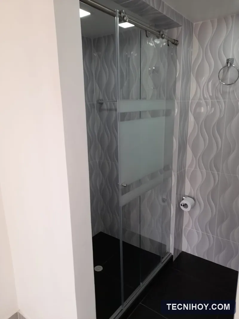 División de baño en vidrio templado con franjas en sandblasting